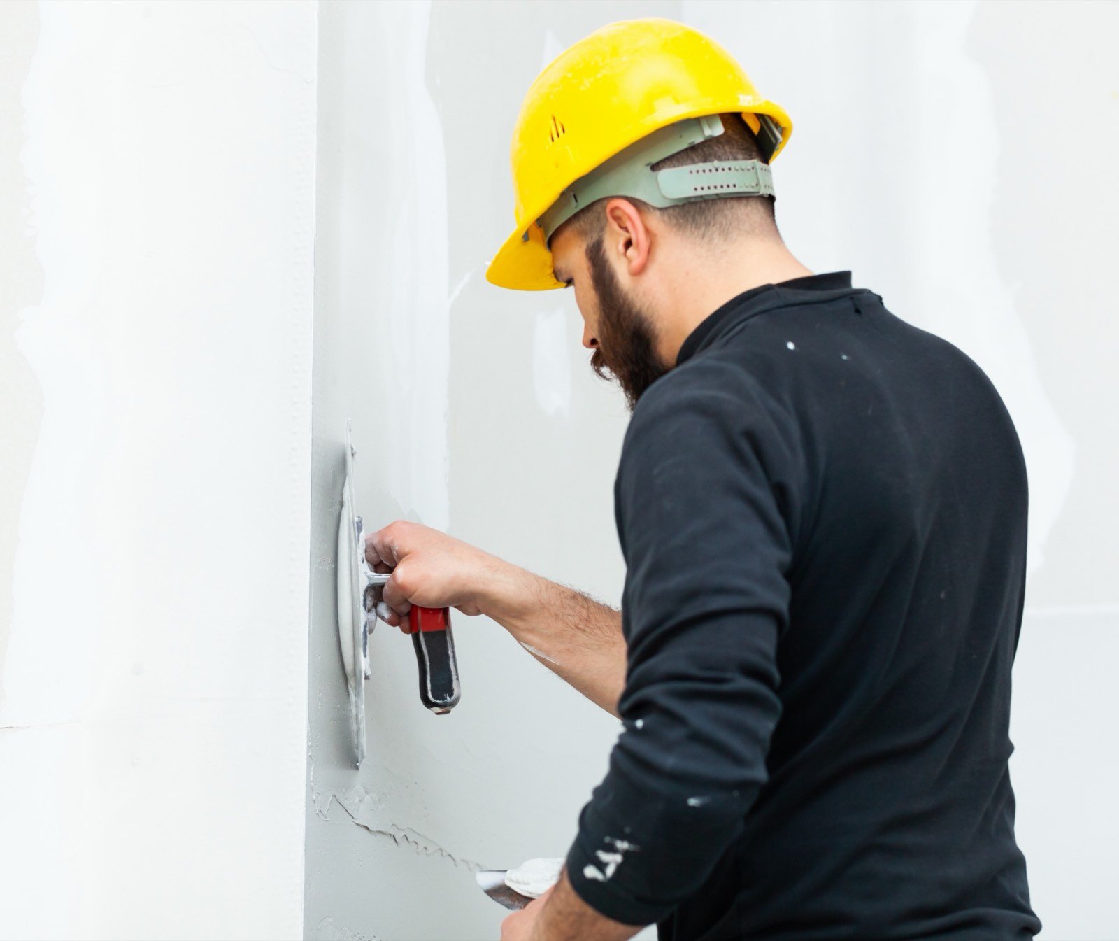 Inspection of smooth gypsum plaster wall finish free of powdery chalking