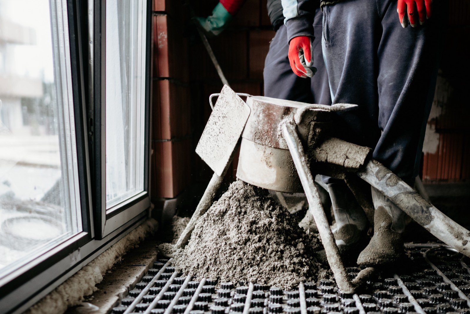 Workers smoothing a newly placed concrete slab
