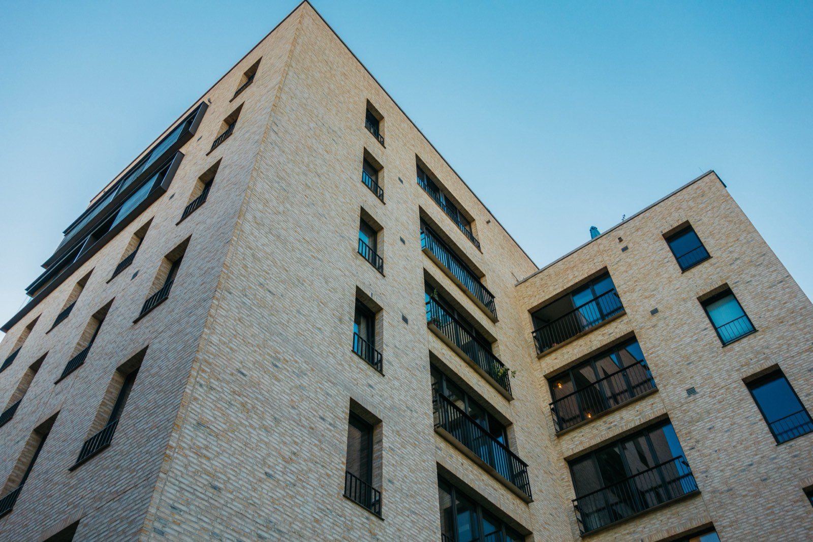 Low-angle view of a modern high-rise facade against open sky